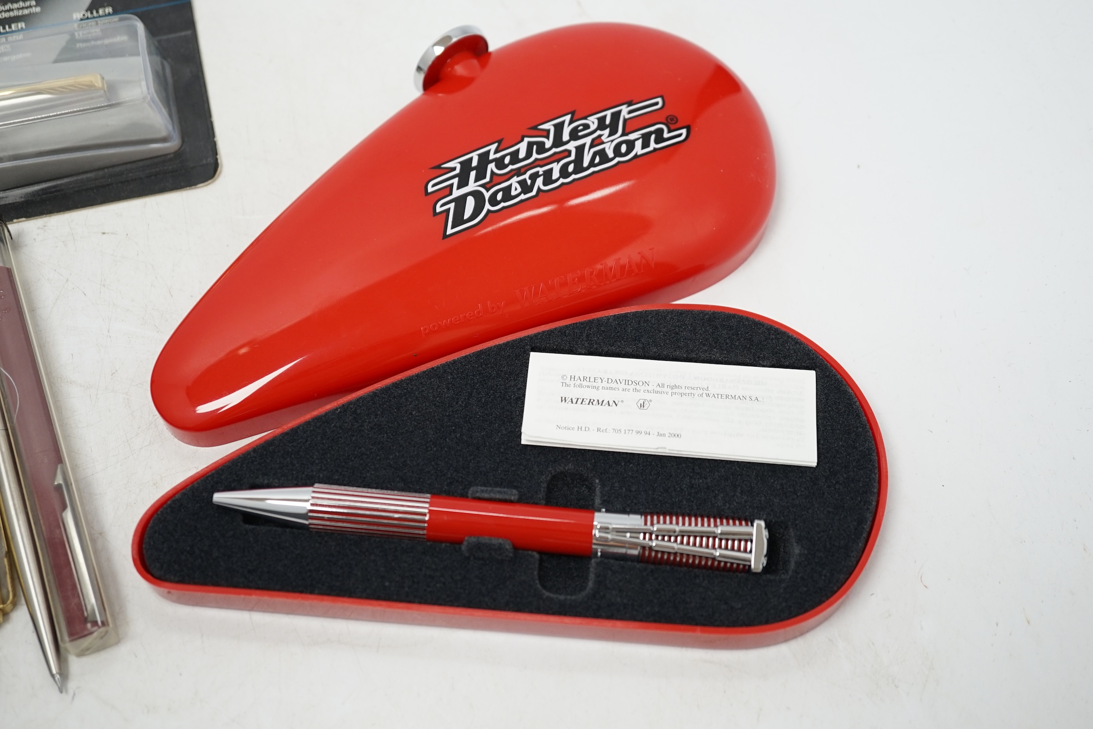A Parker Duofold, a lapis lazuli fountain and ballpoint pen and a faux greenstone fountain pen, a Waterman Harley Davidson ballpoint pen, and nine other Parker / Waterman pens and pencils. Condition - fair